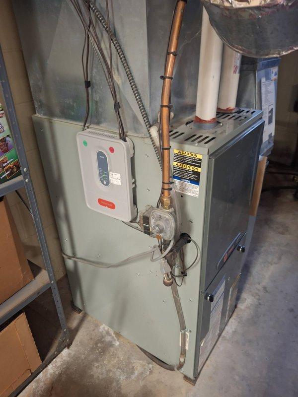 Responded to no cooling complaint on 15-year-old Trane zoned HVAC system. Diagnosed malfunctioning zone motor for living room that was receiving proper signal from control board but failing to activate, preventing zone damper operation and resulting in inadequate cooling distribution throughout the home. Replaced defective zone motor and verified proper damper operation and system functionality upon completion.