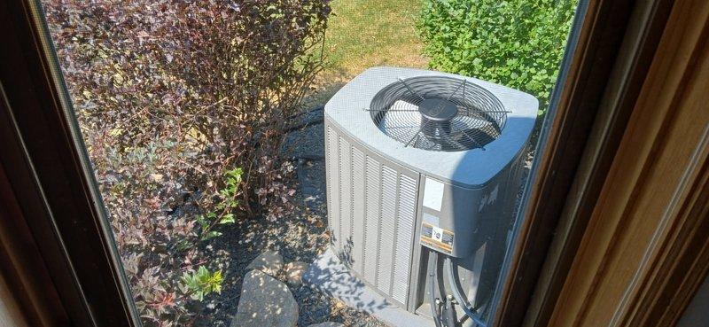 Responded to no cooling complaint on residential split system air conditioning unit. Upon arrival, verified thermostat was calling for cooling at 75 degrees setpoint. Inspected air filter and blower speeds, both found satisfactory. Observed outdoor unit contactor not receiving 24V control voltage from thermostat, though 240V line voltage was present. Tested capacitor, found within specifications. Discovered outdoor coil heavily blocked with cottonwood debris, restricting airflow. Cleaned condenser coil thoroughly, restoring proper airflow. Replaced thermostat batteries and verified wire connections secure.

During further inspection, found blower operating at lowest speed setting and reset button on furnace door switch tripped. Reset safety switch, restoring unit operation. Cycled power to system by disconnecting and reconnecting wiring to confirm proper startup. Checked refrigerant charge and found system operating below optimal levels. Measured supply and return air temperature diffe
