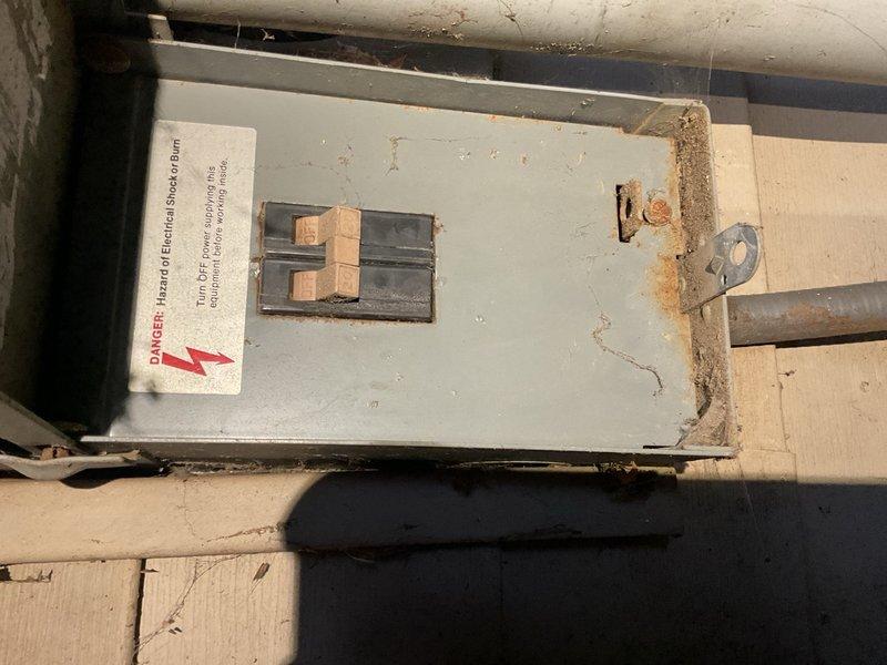 Responded to no cooling complaint on 1997 Lennox R-22 air conditioning system matched with older 80% gas furnace. Upon arrival, found system running but not cooling effectively. Performed diagnostic testing and identified failed dual run capacitor rated 35/5 µF reading 0/0 µF on both terminals. Tested compressor windings which showed open line to ground, confirming no ground short present at time of inspection. Replaced failed dual run capacitor to restore system operation.

Following repair, verified system performance with temperature measurements showing 77°F return air and 58°F supply air, producing acceptable 19°F temperature split across evaporator coil. System restored to operational status with adequate cooling capacity at time of departure.

Advised homeowner that due to system age (26 years old), obsolete R-22 refrigerant phase-out, and overall equipment condition, this repair should be considered temporary. Noted exterior disconnect panel showing significant rust and corrosi