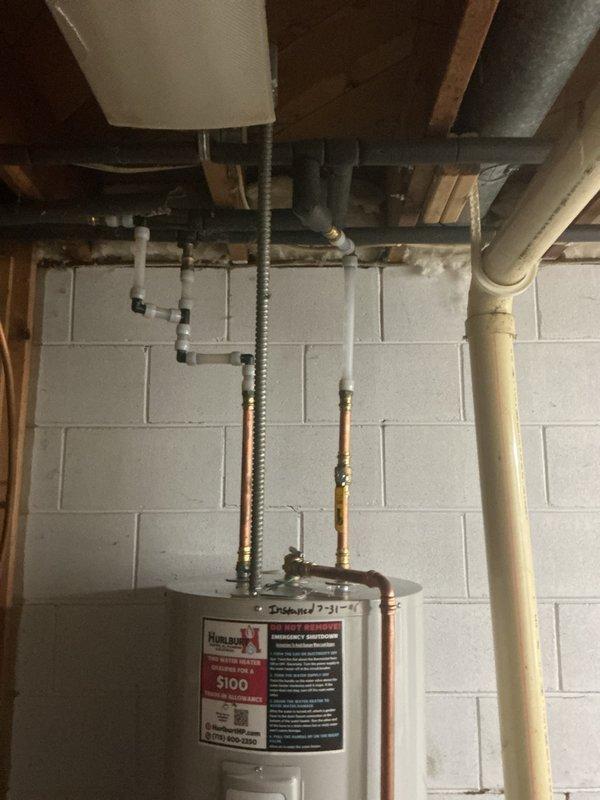 Replaced a failed 50-gallon electric water heater that was experiencing severe corrosion at the base of the tank. Removed the existing deteriorated unit and installed a new Bradford White electric water heater in the basement utility area. Connected copper supply lines to the inlet and outlet ports at the top of the tank, ensuring proper hot and cold water flow. Installed appropriate temperature and pressure relief valve with discharge piping. Verified all electrical connections were secure and compliant with code requirements. Tested the new unit for proper operation and confirmed no leaks at any connection points.