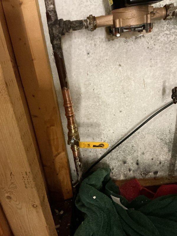 Responded to a water leak at the water meter location with visible spraying on surrounding walls and potential mold concerns. Upon inspection, identified the leak originating from the water meter housing itself. Discovered the property lacked a shut-off valve after the meter, which is necessary for future service and emergency situations. Installed a new brass valve immediately downstream of the meter to provide proper isolation capability. Coordinated with municipal water department for meter replacement due to housing failure. Municipal technician arrived on-site and successfully replaced the defective water meter while we remained to ensure proper completion and verify no additional leaks at connections. All plumbing connections secured and tested. System restored to full operational status with improved serviceability.
