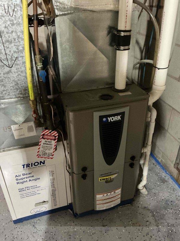 Responded to furnace inspection request following home inspector's observation of black exhaust. Upon activation, identified major flame rollout on one burner while two remaining burners operated normally. Conducted camera inspection of heat exchanger, which revealed a crack at the heat exchanger inlet causing abnormal combustion patterns and excessive soot buildup when blower motor engaged. Documented findings with photographs and reviewed condition with homeowner. Applied red danger lockout tag to unit due to cracked heat exchanger presenting safety hazard. Unit tagged out of service pending replacement options for either complete furnace system or heat exchanger component.