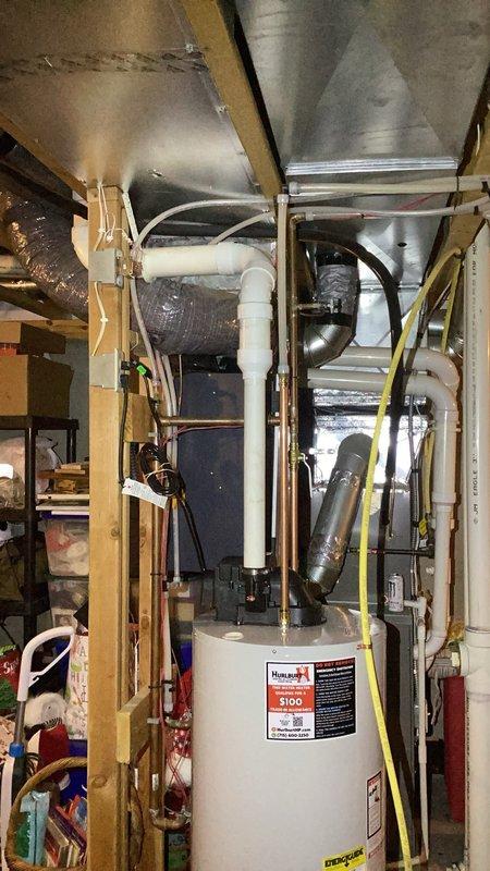 Completed installation of 50-gallon natural gas power vent water heater in basement utility area, replacing existing unit of similar specifications. Connected all supply and discharge lines, installed white PVC venting system extending to proper termination point, and ensured all gas connections met code requirements. Verified proper operation of power vent motor, tested all safety controls, and confirmed adequate combustion air supply. Installation included obtaining applicable permit and final inspection approval. Unit positioned on concrete floor with appropriate clearances maintained for service access and safe operation per manufacturer specifications and local plumbing codes.