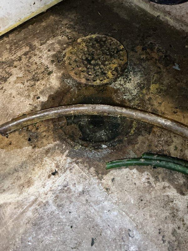 Responded to a floor drain backup complaint and performed diagnostic inspection by scoping the mainline, which confirmed the main sewer line was clear and flowing properly. Isolated the blockage to the floor drain branch line and cabled approximately 30 feet, encountering an obstruction near the entry point which was successfully cleared. Conducted flow testing by running water simultaneously at the laundry tub and pouring multiple buckets of water down the floor drain to verify complete clearance, with no backup observed and all drains functioning properly upon completion.