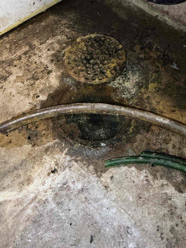 Responded to a floor drain backup complaint and performed diagnostic inspection by scoping the mainline, which confirmed the main sewer line was clear and flowing properly. Isolated the blockage to the floor drain branch line and cabled approximately 30 feet, encountering an obstruction near the entry point which was successfully cleared. Conducted flow testing by running water simultaneously at the laundry tub and pouring multiple buckets of water down the floor drain to verify complete clearance, with no backup observed and all drains functioning properly upon completion.