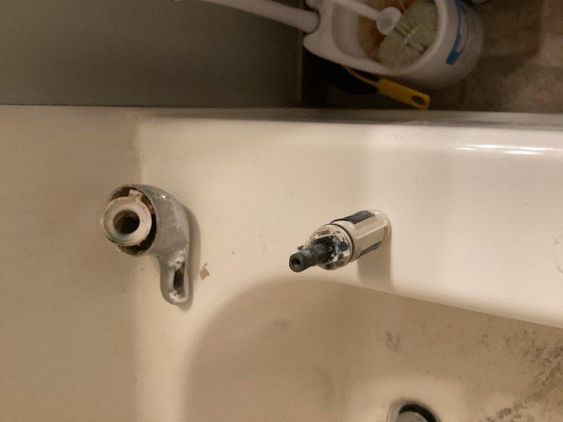 Responded to service call for leaking shower handle on extremely aged Moen shower valve with no visible manufacturer markings. Upon inspection, identified severe hard water buildup affecting cartridge operation. Successfully replaced worn shower cartridge, but handle mount broke during removal due to age and mineral deposits. Installed new mounting hardware to complete repair and restore full functionality to shower valve assembly.