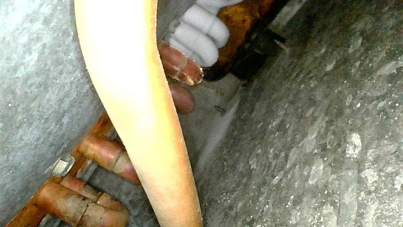 Responded to no cooling complaint on 20+ year old R-22 system blowing warm air. Performed diagnostic inspection of outdoor condenser unit including capacitor, contactor, and electrical connections. Attempted refrigerant pressure readings but unable to connect gauges due to bent suction line service port. Inspected indoor blower assembly and evaporator coil. Measured supply air temperature split at only 3°, indicating insufficient cooling capacity. Observed metering device freezing during operation, indicating restriction and low refrigerant charge. System requires metering device replacement and refrigerant recharge; however, due to age of equipment, obsolete R-22 refrigerant, and extent of repairs needed, recommended system replacement consultation rather than repair. Documented equipment condition with photographs and advised scheduling comfort advisor visit to review replacement options.