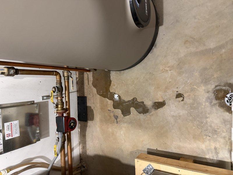 Responded to water leak concern in utility area following initial tune-up visit. Upon inspection, identified failed expansion tank on indirect domestic water heater as source of water accumulation on floor, evidenced by wall staining and moisture damage visible in mechanical room. Contacted homeowners with findings and diagnosis; customer approved deferring expansion tank replacement until the following Monday.