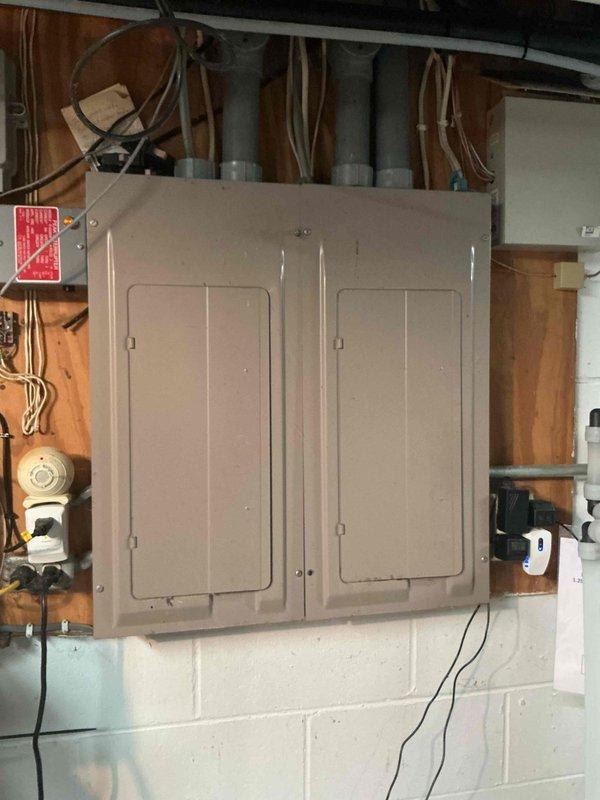 Performed comprehensive AC tune-up on Carrier system, including inspection of electrical components, outdoor coil cleaning, filter check, and evaporator drain verification. Upon system startup, diagnosed low refrigerant condition with only 10° temperature split, low-side pressure significantly below specification, and insufficient subcooling. Added refrigerant charge and UV dye to system for future leak detection capability. Post-service testing confirmed improved performance with 18° temperature split achieved, bringing system back to proper operating parameters.