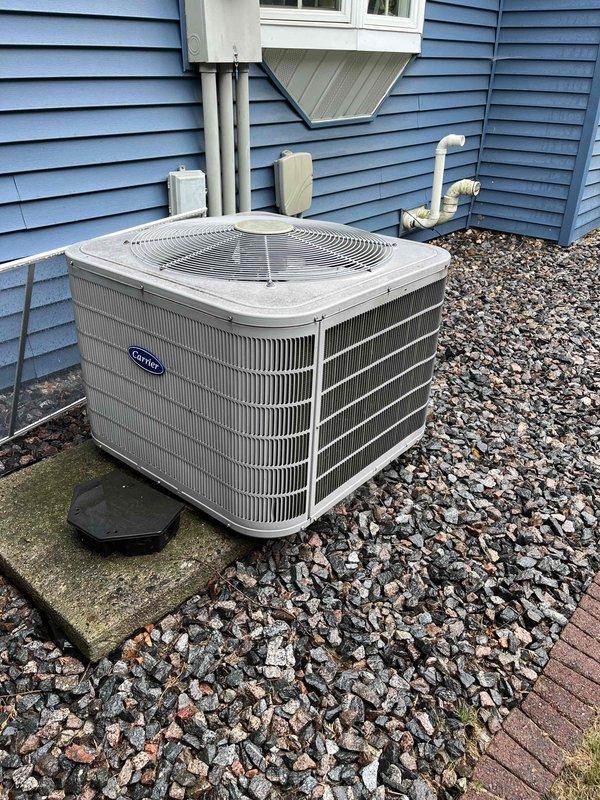 Performed comprehensive AC tune-up on Carrier system, including inspection of electrical components, outdoor coil cleaning, filter check, and evaporator drain verification. Upon system startup, diagnosed low refrigerant condition with only 10° temperature split, low-side pressure significantly below specification, and insufficient subcooling. Added refrigerant charge and UV dye to system for future leak detection capability. Post-service testing confirmed improved performance with 18° temperature split achieved, bringing system back to proper operating parameters.