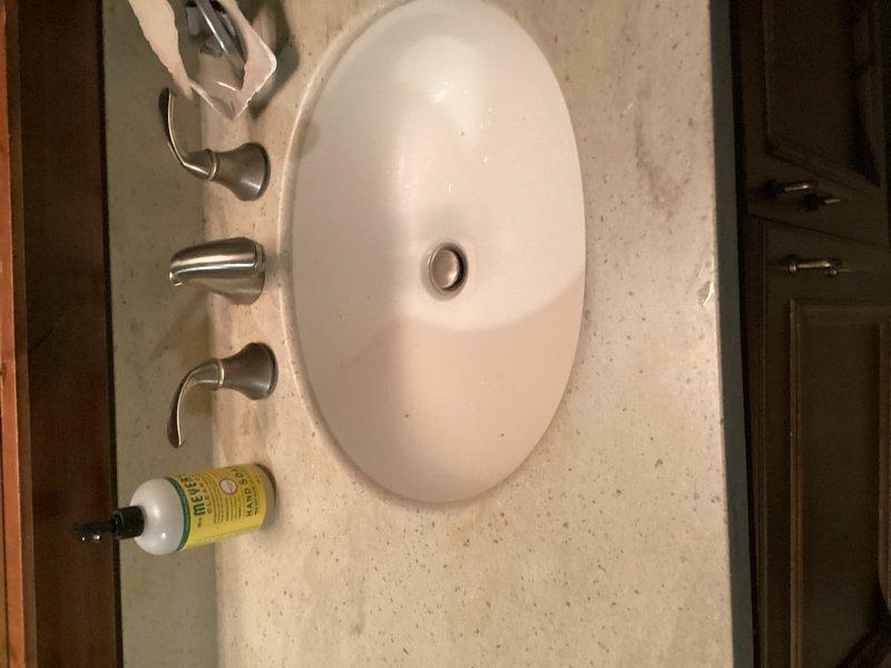 Responded to service call for hot water issue in shower and water leak from upstairs bathroom into basement. Diagnosed faulty shower valve in basement bathroom with broken or missing internal components causing leak and loss of hot water function. Valve determined to be non-repairable and requires full replacement, which homeowner will coordinate with planned bathroom renovation involving removal of existing tub/shower unit. Inspected upstairs bathroom and located source of leak above basement valve area. Found broken showerhead with arm still lodged in shower eared elbow. Successfully extracted showerhead arm from fitting without requiring wall penetration. Advised homeowner to purchase replacement showerhead and arm assembly for reinstallation.