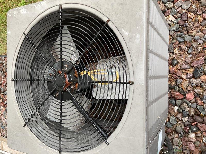 Performed preventive maintenance on a 2006 WeatherKing air conditioning system with matching furnace serving an R-22 refrigerant application. Installed new 16x20x1 air filter and cleaned condenser coil. System was operated for approximately 15 minutes and confirmed to be cooling properly with supply air temperature measured at 56°F and return air at 75°F, producing a 19°F temperature split within normal operating range.

During inspection, identified that the previously installed condenser fan motor is an aftermarket replacement that appears dimensionally incorrect for this unit. The motor body length causes the fan blade to sit too deep within the shroud, which may restrict condenser airflow and negatively impact head pressure and overall cooling performance. This condition requires verification and possible correction.

Outdoor service conditions were compromised by rain and significant ant infestation around the condenser unit, which limited safe access and required intermittent wor