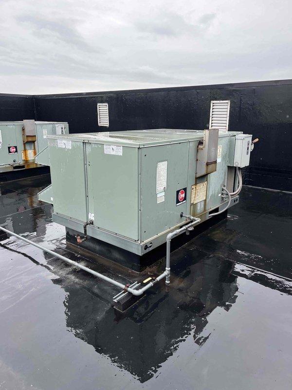 Responded to no cooling call on northwest rooftop unit. Found low/high pressure switch tripped, preventing compressor operation. Reset pressure switch successfully, restoring compressor function and cooling operation. Due to wet roof conditions from rain, deferred condenser coil cleaning and maintenance, scheduling follow-up service to perform complete tune-up including coil rinse and cleaning to ensure optimal system performance.