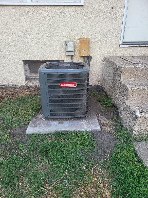 Responded to service call for one-year-old Goodman air conditioning system not adequately cooling residence. Unit was running continuously but failing to reach desired temperature setpoint. Upon inspection, found condenser coil heavily soiled with debris restricting airflow through the unit. Cleaned condenser coil thoroughly to restore proper heat exchange efficiency. Verified all other system components, electrical connections, and refrigerant operation were functioning within normal parameters. Advised customer that system performance should improve with cleaner condenser, but to monitor performance during hotter ambient conditions and contact for follow-up if cooling issues persist.