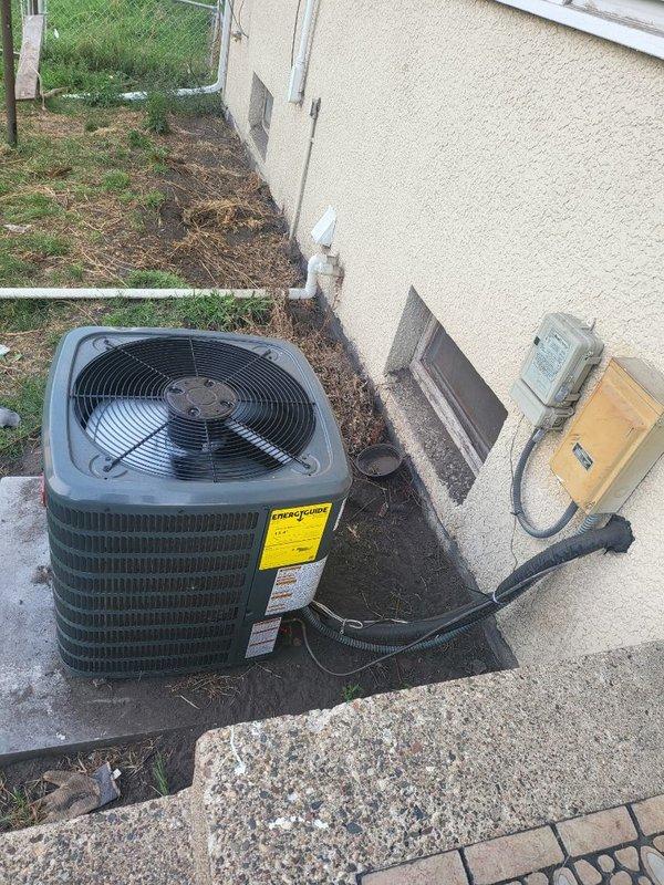 Responded to service call for one-year-old Goodman air conditioning system not adequately cooling residence. Unit was running continuously but failing to reach desired temperature setpoint. Upon inspection, found condenser coil heavily soiled with debris restricting airflow through the unit. Cleaned condenser coil thoroughly to restore proper heat exchange efficiency. Verified all other system components, electrical connections, and refrigerant operation were functioning within normal parameters. Advised customer that system performance should improve with cleaner condenser, but to monitor performance during hotter ambient conditions and contact for follow-up if cooling issues persist.