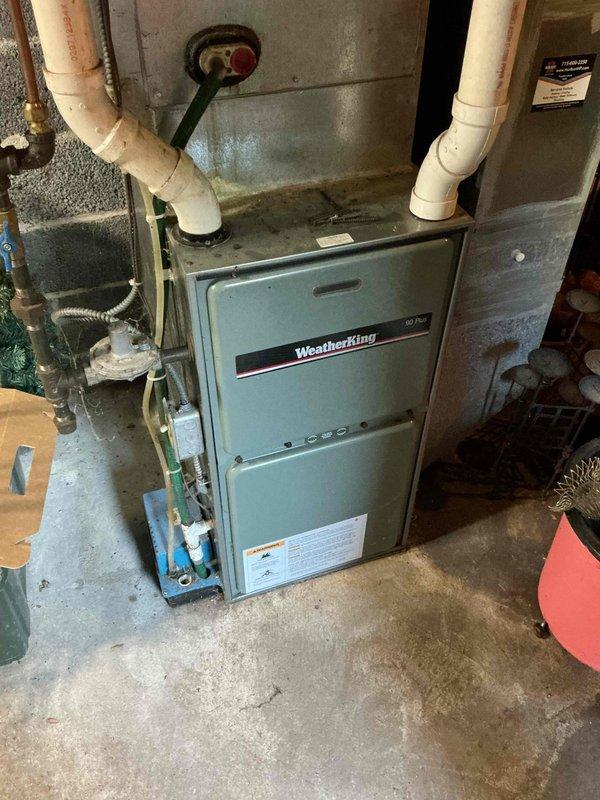 Responded to no cooling complaint on 29-year-old R22 system. Diagnosed blower motor failure preventing indoor air circulation. Temporarily wired blower motor to run continuously to restore air movement while researching parts availability and repair options for the aging WeatherKing unit.