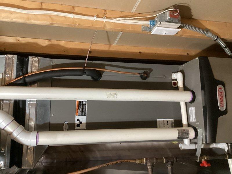 Responded to callback for air conditioning system not cooling. Upon arrival, found furnace control board not powered and 24V fuse open. Reset fuse and cycled system to restore operation. Performed comprehensive system check including thermostat wiring, control board connections, condenser operation, and capacitor testing—all components functioning within normal parameters. Addressed thermostat programming concerns by removing batteries, verifying C wire connection, and instructing occupants on proper use of Hold function to override scheduling feature. System restored to normal cooling operation.