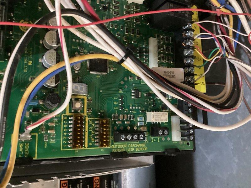 Responded to callback for air conditioning system not cooling. Upon arrival, found furnace control board not powered and 24V fuse open. Reset fuse and cycled system to restore operation. Performed comprehensive system check including thermostat wiring, control board connections, condenser operation, and capacitor testing—all components functioning within normal parameters. Addressed thermostat programming concerns by removing batteries, verifying C wire connection, and instructing occupants on proper use of Hold function to override scheduling feature. System restored to normal cooling operation.