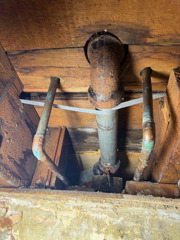 Responded to emergency water leak affecting basement ceiling and lower unit. Upon arrival, identified source as kitchen sink drain line with galvanized pipe severely corroded and pitted in two locations. Water supply was shut off to prevent further damage. Removed deteriorated section of galvanized drain pipe and replaced with new piping. Tested system for proper drainage and verified leak was fully resolved with no additional water intrusion.