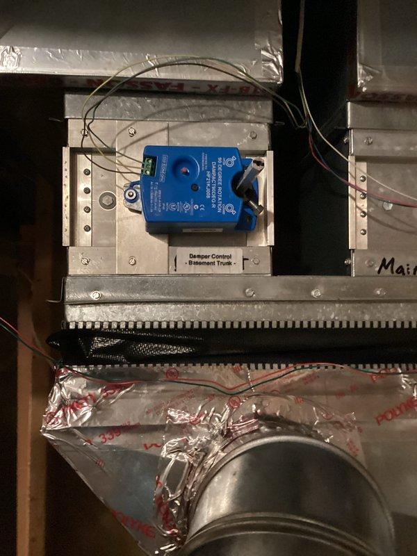 Responded to service call for malfunctioning zone damper system. Upon inspection, identified failed damper motor producing audible ticking noise, indicating internal mechanical failure. Removed defective motorized damper actuator from existing metal ductwork assembly and mounting frame. Installed new replacement damper motor, securing unit to mounting plate within the duct system. Connected electrical wiring to actuator, ensuring proper voltage and control signal integration with existing zone control system. Verified damper operation through full range of motion and confirmed silent, smooth functionality. System restored to normal operation with proper zone temperature control capability.