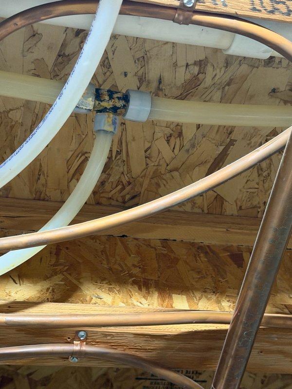 Responded to two reported basement leaks. First leak investigated in shower area where water damage was evident on siding and drywall adjacent to glass door. Removed trim plate and opened wall to inspect water lines and shower valve; no source of leak detected from plumbing components. Identified glass door positioned approximately one inch above shower pan with similar damage pattern on opposite side of door, indicating improper seal as likely cause. Recommended replacement of shower door seal to homeowner. Second leak located in mechanical room traced to failed PEX fitting. Successfully replaced faulty 3/4" x 1/2" PEX tee fitting to resolve mechanical room leak.
