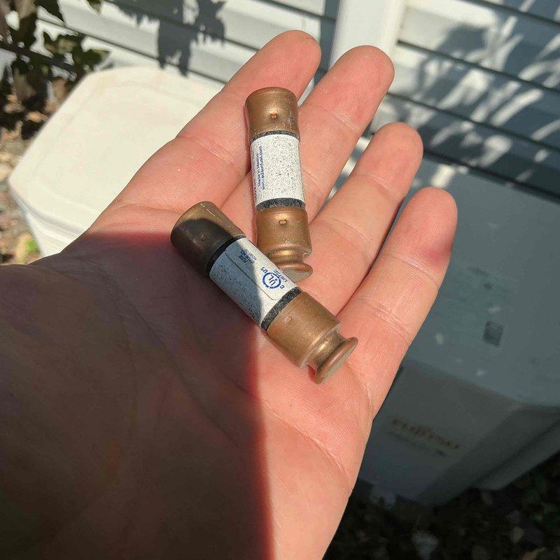 Responded to a no cooling call on a 15-year-old Fujitsu mini split system that stopped operating following a recent power outage. Upon arrival, performed diagnostic testing and discovered both fuses in the outdoor disconnect had failed. Replaced the failed disconnect fuses and attempted to restart the system, but the indoor head unit remained inoperative.

Removed the cover from the indoor head unit to continue troubleshooting and located an additional failed 3.15 amp glass fuse on the control board. This component requires special ordering and is not a standard stock item. Explained to the customer that additional components may have sustained damage from the power surge event, but a complete assessment cannot be performed until the glass fuse is replaced and the system is powered back up.

Documented the failed components with photographs showing both the disconnect fuses and the internal glass fuse. Submitted parts requisition for the 3.15 amp glass fuse and will provide cost estima