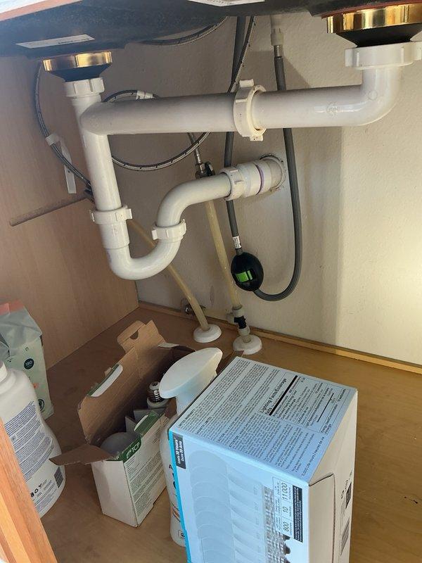 Responded to a kitchen drain clog causing standing water in the sink basin opposite the garbage disposal, with drainage taking approximately one hour to clear. Performed mechanical snaking of the kitchen drain line to remove blockage and restore proper water flow. Verified drainage system operation and confirmed the existing garbage disposal and plumbing connections were functioning correctly after clearing the obstruction.