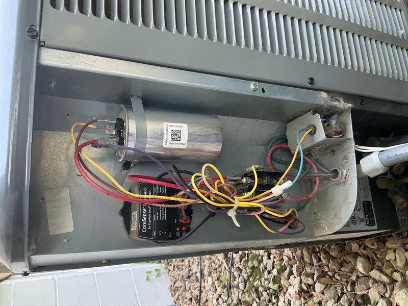 Responded to no cooling complaint on Amana air conditioning system installed four years ago. Upon arrival, confirmed outdoor fan was running but unit not producing cool air. Inspected attic-mounted air handler and found it in acceptable condition. Replaced dirty air filter and proceeded to outdoor condenser unit for further diagnostics.

Discovered condenser coils heavily clogged with cottonwood debris restricting airflow. Tested dual-run capacitor and found it reading 10/5 MFD against rated specification of 45/5 MFD, indicating significant capacitor degradation affecting compressor and fan motor operation. Advised customer of findings and recommended capacitor replacement and system cleaning to restore cooling function.

Replaced failed dual-run capacitor with proper 45/5 MFD rated component. Thoroughly cleaned condenser coils to remove cottonwood accumulation and restore proper heat exchange. Performed complete system tune-up including all electrical connections and component inspect