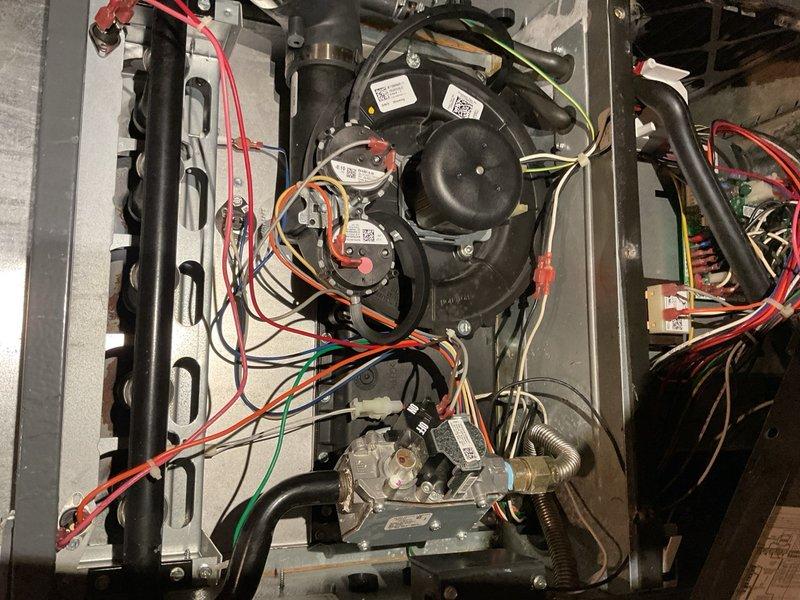 Performed comprehensive A/C maintenance evaluation on a 2004 home with original Nordyne air conditioning unit and 2020 Goodman single-stage 100,000 BTU furnace with ECM blower serving a two-zone system. Inspection revealed system in poor overall condition with multiple critical issues requiring immediate attention. Discovered active condensate leak from evaporator coil running down the back of the furnace. Upon removal of evaporator front cover, found delta plate and drain pan area visibly rusted through, indicating prolonged moisture exposure and structural deterioration. 

Conducted thorough furnace safety inspection which identified heat exchanger overheating at the back header, a serious safety concern. Noted improper equipment matching between single-stage furnace and two-zone system configuration, creating operational inefficiency and accelerated equipment wear. This mismatch poses ongoing concerns for long-term reliability and safe operation of the heating system.

Documented al