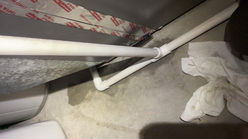 Responded to callback for condensate drain leak on recently installed furnace and AC system. Removed and replaced defective PVC elbow joint on condensation discharge line with proper solvent welding. Performed multiple water flow tests to verify leak repair and confirm proper drainage function with no further leakage detected at joint connection.