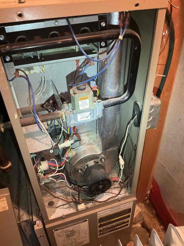 Responded to no cooling call on 29-year-old Goodman air conditioning system with both indoor and outdoor fans not operating. Upon arrival, performed diagnostic evaluation and identified failed dual run capacitor exhibiting visible bulging at top, indicating internal failure. Replaced defective dual capacitor with new unit, restoring operation to both condenser fan motor and compressor.

Following capacitor replacement, system initiated cooling cycle successfully. Conducted comprehensive system performance evaluation including electrical component inspection, airflow verification, and refrigerant system assessment. Contactor tested and found operational with proper contact engagement. Condenser coil inspected and confirmed clean with adequate airflow. Indoor air filter verified clean with no restriction to airflow.

Measured temperature split across evaporator coil and confirmed 20-degree differential, indicating proper refrigerant charge and heat exchange. However, noted elevated head 