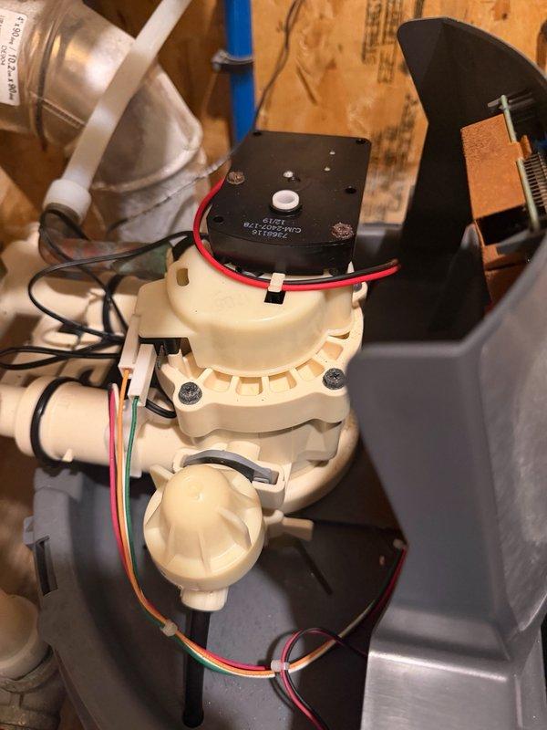 Responded to service call for water softener displaying ERR1 error code and failing to drain properly. Upon inspection, diagnosed 7-year-old unit with malfunctioning motor preventing water discharge through drain port during regeneration cycle. Motor mechanism not operating correctly, causing system to fill with water and halt regeneration process. Evaluated cycle controller assembly and drainage components to confirm motor failure as root cause. Documented equipment condition with photographs showing cycle controller, valve assembly, PVC plumbing connections, and complete water treatment system configuration including associated filtration components. Provided customer with multiple repair options including motor replacement, complete resin rebed service, or new water softener unit installation to restore proper system operation.