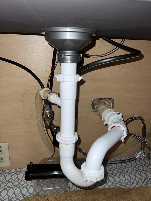 Responded to water leak under kitchen sink. Upon arrival, identified leak at horizontal drain pipe connection from P-trap assembly. Disconnected and inspected horizontal pipe from trap arm where separation had occurred. Reconnected drain assembly, ensuring proper alignment and secure connections at all joints. Verified all PVC connections were tight and leak-free. Tested system by running water through sink drain and confirmed no active leaks present. Kitchen sink plumbing restored to proper working condition.