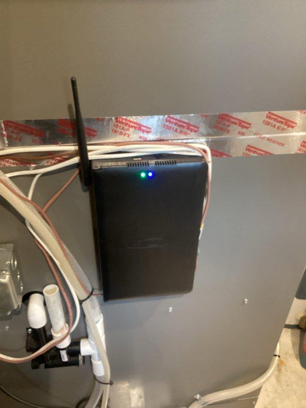 Responded to ongoing thermostat communication issues with smart hub requiring repeated breaker resets to restore functionality. Documented existing S40 smart hub installation with photos showing wireless connectivity device mounted to HVAC panel with active LED indicators and external antenna. Submitted parts order for replacement S40 unit due to persistent connection failures affecting system operation.