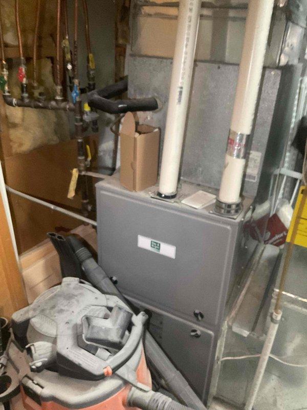 Responded to no cooling call on 10-year-old air conditioning system affecting entire home with reported thumping sound. Upon arrival, discovered electrical issue preventing breaker from resetting, which prohibited system operation. Diagnosed failed breaker unable to maintain connection to outdoor condensing unit. System required licensed electrician to address electrical supply issue before HVAC repairs could proceed. Documented equipment location and existing basement mechanical systems including furnace, water heater, and associated plumbing connections for reference.