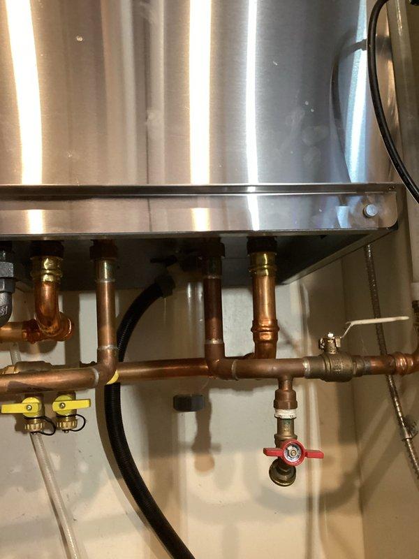 Responded to service call for leaking backflow prevention valve on boiler system. Conducted thorough assessment of existing plumbing infrastructure and documented current configuration with detailed photographs. Evaluated customer request for hot water recirculating pump installation to minimize water waste during shower warm-up periods. Inspected potential routing options through bathroom wall areas with existing tile work and examined water heater mechanical room connections including copper supply lines, gas shutoff valves, and brass fittings. Gathered comprehensive measurements and technical specifications required for preparing two separate project estimates: backflow preventer repair/replacement and hot water recirculation system installation.