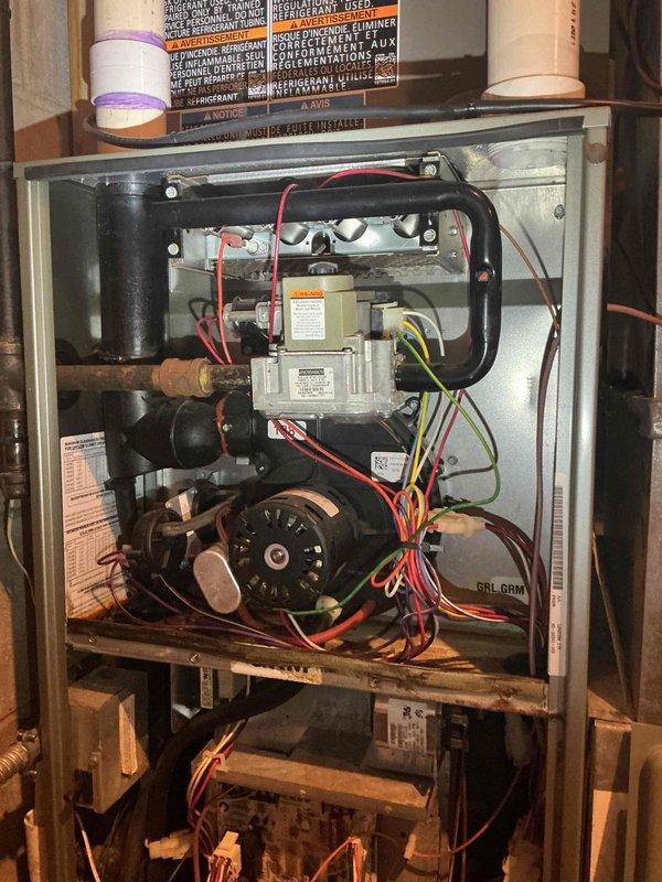 Responded to service call for AC system not maintaining temperature below 78 degrees on hot days. Performed comprehensive system inspection revealing contactor, capacitor, condenser coil, and refrigerant charge all within normal operating parameters. Subcool readings in specification despite stripped locking cap on suction line. Identified potentially restrictive air filter and replaced with lower restriction filter to improve airflow. Deactivated humidifier bypass damper and verified proper blower motor speed. Measured temperature drop across evaporator coil at 19 degrees, confirming adequate system performance. Replaced malfunctioning Alexa smart thermostat with original Honeywell unit provided at installation; discovered Alexa thermostat failed to power up upon system restart, identifying root cause of temperature control issues. System tested and operating properly with no further concerns noted at time of departure.