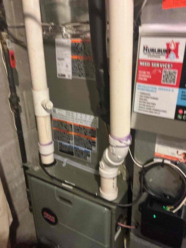 Responded to service call for AC system not maintaining temperature below 78 degrees on hot days. Performed comprehensive system inspection revealing contactor, capacitor, condenser coil, and refrigerant charge all within normal operating parameters. Subcool readings in specification despite stripped locking cap on suction line. Identified potentially restrictive air filter and replaced with lower restriction filter to improve airflow. Deactivated humidifier bypass damper and verified proper blower motor speed. Measured temperature drop across evaporator coil at 19 degrees, confirming adequate system performance. Replaced malfunctioning Alexa smart thermostat with original Honeywell unit provided at installation; discovered Alexa thermostat failed to power up upon system restart, identifying root cause of temperature control issues. System tested and operating properly with no further concerns noted at time of departure.