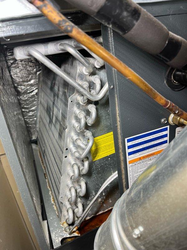 Completed preventive maintenance tune-up on a 7-year-old Goodman central air conditioning system originally installed in 2018. Performed comprehensive AC inspection including filter replacement with 14x20x1 filter, verified evaporator coil was clean with proper drainage, conducted electrical testing with all readings within manufacturer specifications, cleaned outdoor condenser unit, and ran system through full operational cycle for 15 minutes confirming proper performance with temperature split exceeding 17 degrees across the coil. All components functioning properly with no deficiencies noted.