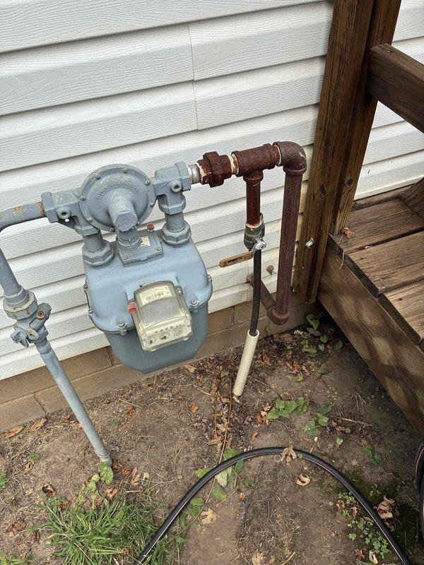 Responded to service call for gas line removal and capping at property where pool heater was being decommissioned. Located gas supply line off the main meter, identified nipple connection dropping to shutoff valve with copper line continuation to pool heater. Shut off valve, disconnected copper line, and installed 3/4" plug directly into shutoff valve. Verified shutoff valve integrity by testing for gas leaks when opened, confirmed no gas flow to pool heater location, and ensured complete isolation of decommissioned gas line.