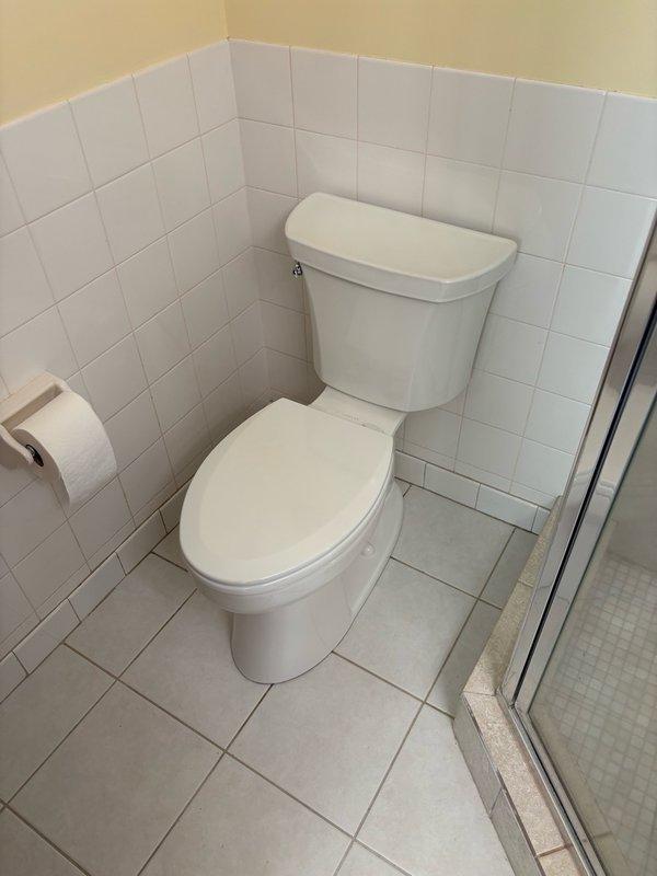 Replaced three toilets in the residence with new Kohler fixtures, including two elongated bowl models and one round bowl model. Installed new angle stops for all three toilet installations to ensure proper water supply control and long-term reliability. Removed existing kitchen faucet and installed new Delta pull-down model for improved functionality and performance.

Following installation, conducted thorough leak testing by flushing each toilet a minimum of five times to verify proper operation and seal integrity. Applied clear silicone caulking around the base of each toilet to secure fixtures and prevent water infiltration. All fixtures tested successfully with no leaks detected. Work areas were cleaned and inspected upon completion. All installations meet manufacturer specifications and industry standards for residential plumbing fixtures.
