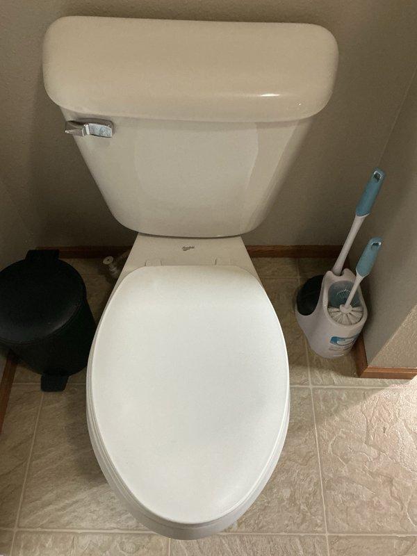 Responded to a leaking toilet in the master bathroom. Upon inspection, identified a faulty fill valve leaking from the top of the tank, causing water to run down the side and pool on the floor beneath the toilet. Removed the defective fill valve and installed a new replacement unit, restoring proper operation and eliminating the leak. Customer also reported a slight rotten egg odor in the water supply; advised that the well had been previously shocked and a filtration system installed, and recommended potential water testing and additional well treatment if the odor persists.