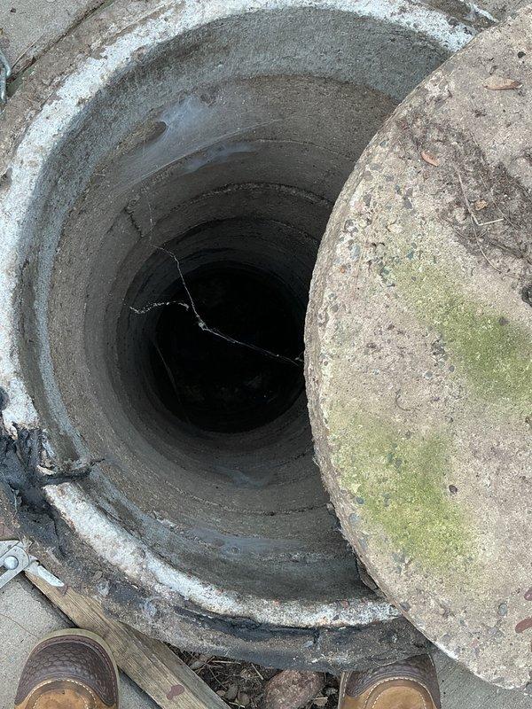 Responded to emergency call for basement flooding caused by backed-up sewer system. Upon arrival, found standing water throughout basement utility room and discovered main sewer tank completely full of sewage and toilet paper. Accessed main line cleanout opening and assessed condition of system. Customer arranged for septic pumping service to address full tank. Documented conditions of flooded basement mechanical room and main line access point for records.