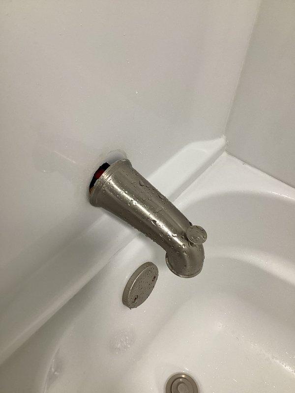 Responded to priority service call for loose bathtub spout in shower area. Upon inspection, confirmed spout was improperly secured with PEX connection lacking adequate backing support or strapping. Created access point in rear wall to expose plumbing, properly strapped and secured the tub spout assembly to structural framing, and restored wall access. Fixture now stable and fully operational.