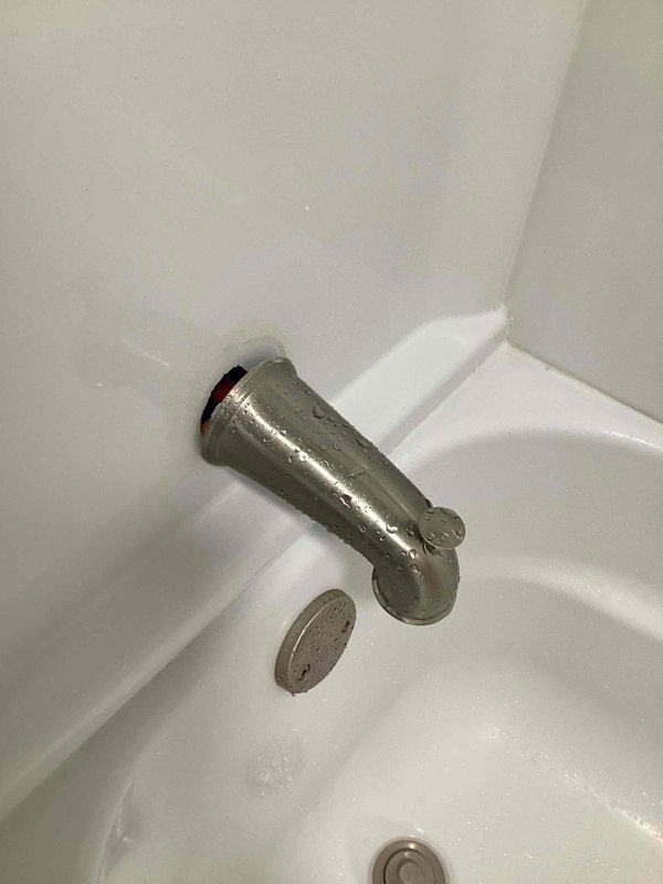 Responded to priority service call for loose bathtub spout in shower area. Upon inspection, confirmed spout was improperly secured with PEX connection lacking adequate backing support or strapping. Created access point in rear wall to expose plumbing, properly strapped and secured the tub spout assembly to structural framing, and restored wall access. Fixture now stable and fully operational.