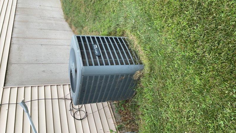 Completed comprehensive maintenance tune-up on two residential air conditioning systems as part of annual maintenance agreement. Performed standard seasonal inspection procedures including cleaning both outdoor condenser units, removing accumulated vegetation including vines and grass growth from unit perimeters and surfaces. Documented equipment condition with photos showing proper equipment labeling, refrigerant line routing, and unit placement on concrete pads with adequate clearance for airflow and service access.