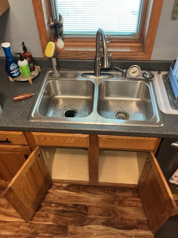 Responded to service call for kitchen sink backing up due to deep clog in drain line. Upon arrival, determined that previous cabling attempts by homeowner had been unsuccessful in clearing the obstruction. Diagnostic assessment indicated grease buildup as the primary cause of the blockage.

Cabled the entire kitchen drain line from the sink basin through to the mainline connection, successfully removing all debris and grease accumulation from the pipe. Utilized drain camera to verify complete clearance of the line and confirm proper flow throughout the entire drain system. Conducted thorough operational testing by filling and draining both basins of the double-sink multiple times to ensure proper drainage and flow rate. Inspected all connections and verified no leaks were present in the system. Kitchen sink restored to full working condition with clear drainage confirmed.