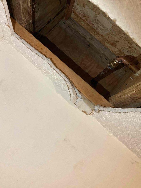 Accessed crawl space through floor opening to inspect and address plumbing concerns. Evaluated exposed copper piping running between floor joists and assessed structural framing conditions. Completed minor repair work on plumbing system and documented existing conditions of access point and surrounding infrastructure for customer records.