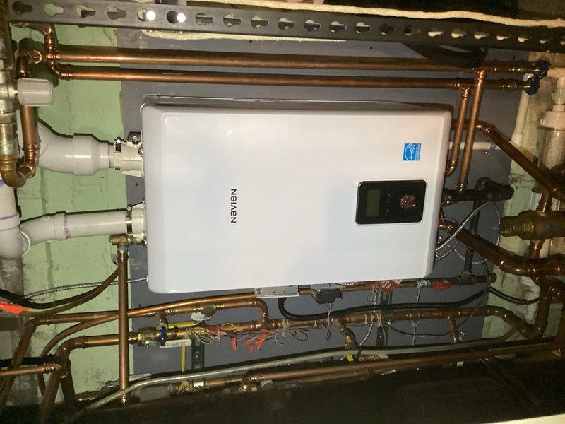 Responded to service call for Navien tankless water heater system experiencing operational issues due to faulty factory transformer. Retrieved correct replacement transformer and returned to site to complete repair. Removed defective transformer from boiler unit and installed new factory-spec replacement component. Following installation, performed comprehensive system testing including cycling all heating zones and verifying domestic hot water functionality. Confirmed all zones responded properly and system returned to normal operation with proper voltage readings and no error codes displayed on control panel.
