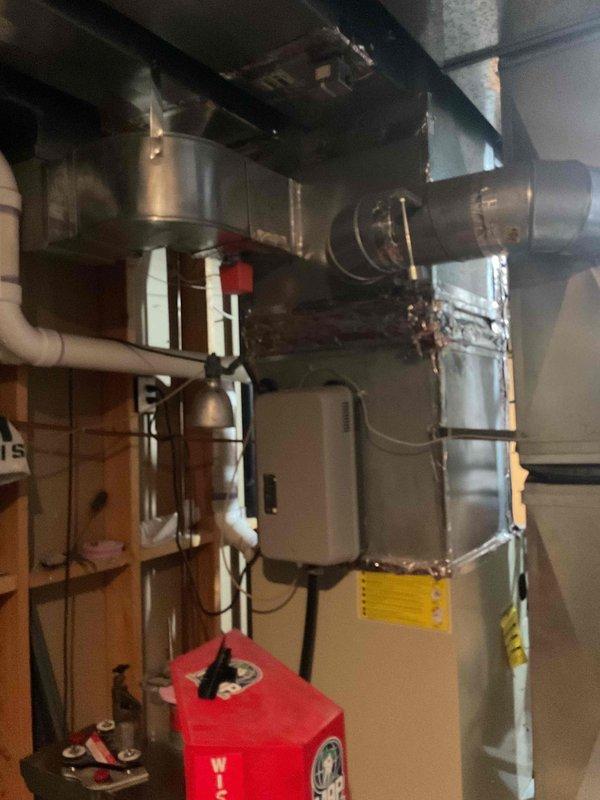 Responded to no cooling complaint on residential HVAC system. Upon arrival, discovered frozen refrigerant line from outdoor condenser to indoor coil and severely restricted airflow due to dirty evaporator coil. Used digital manifold gauges to assess system pressures and confirmed abnormal operating conditions. Found condensate drainage issue causing water accumulation in mechanical room, related to previous condenser installation. Evaporator coil access proved challenging due to metal bracket assembly requiring disassembly. Placed collection bucket to manage condensate leakage. System requires evaporator coil cleaning or replacement and proper drainage configuration. Scheduled return visit with additional technician to facilitate coil removal and complete necessary repairs.